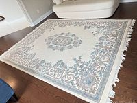 full view of rectangular floral rug on hardwood floor
