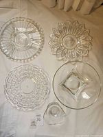Five clear glass pieces laid out together