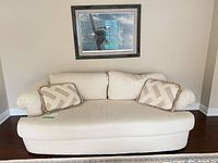 Front view of cream Sherhill loveseat with two pillows