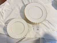 Stacks of dinner and salad plates on cloth