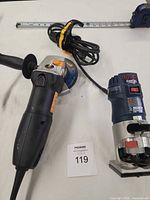 Overall view of Bosch palm router and Walter angle grinder with cords and side handle