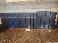 Full row of navy Canadian Geographic binders with years 1982-2002 visible