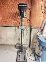 Front view of Delta 16-1/2 floor drill press showing full height, head unit, table, and base