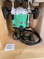 Hitachi plunge router with power cord and handles