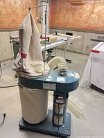 Full view of JET DC-650 dust collector with bags and hose
