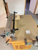 Top view of Leigh D4 jig mounted on wooden bench