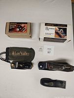 Overall lot layout showing five items: two boxed Veritas tools, two loose planes including one in Lee Valley pouch, Record bench plane and separate handle