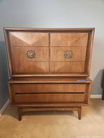 Front view of walnut dresser showing four drawers and brass-tone pulls