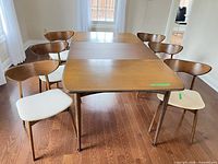 table top with leaf installed and six chairs around