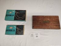 Two M&W micrometer cardboard boxes and Starrett wooden case closed