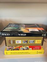 Stack showing four of the books including Images of the World on top