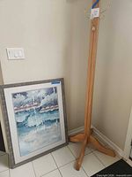 Oak coat rack and framed artwork side by side