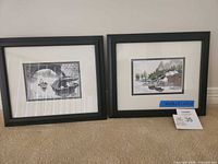 Both framed embroidered artworks side by side