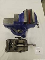 Top view of blue bench vise with secondary milling clamp