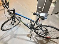 Angled overhead view of entire Rocky Mountain hybrid bike displaying frame, wheels, drivetrain, and attached cable lock
