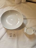Stacked bowls and spoon rests on white surface