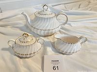 Teapot, sugar bowl with lid, creamer shown together