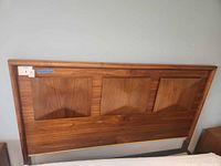 Front view of walnut headboard showing three book-matched panels