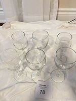Top view of six clear stemmed wine glasses