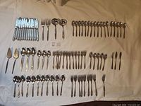 Full layout of flatware pieces on cloth