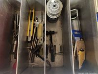 overview of metal divider box with knives, taps, bits