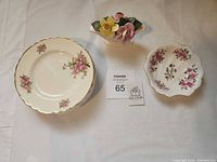 Top view of seven plates, floral figurine and trinket dish