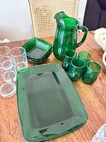 overall view showing green pitcher, tumblers, platter, bowls and clear glasses