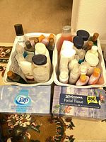 Two white baskets filled with various hair care bottles alongside two tissue boxes