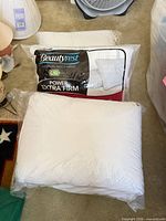 Two sealed Beautyrest pillows, packaging visible