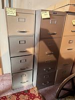 Beige and grey filing cabinets front view showing four drawers each