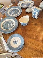 Group view of all blue and white transferware pieces on table