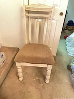 Front view of cream wood dining chair with beige upholstered seat