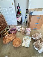 overview of all items on floor: baskets, plush bunnies, carousel, stickers