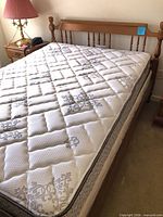 Full view of mattress on wooden frame