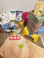 Group shot of entire lot with tissue boxes, step stool, bath rug, toilet paper pack, loose rolls, soaps, soap mold