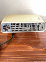 Front view showing grille, control knob, power cord