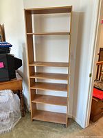 Full view of the 6-shelf light brown engineered wood bookcase