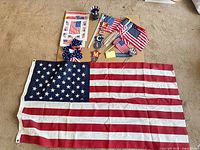 Entire lot showing large flag, small flags, banner, bow, stickers, votive