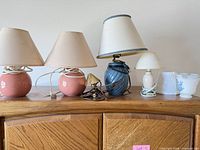 Group shot of all lamps and shades on wooden surface