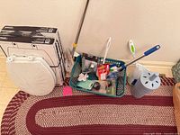Group shot showing both toilet seats, cleaning tools, basket with packaged parts