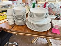 Stacks of Madeiras dinner plates, salad plates, bowls, cups, sugar bowl on table