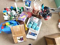 Full lot overview showing cutting boards, cleaning supplies, utensils, mugs, canisters