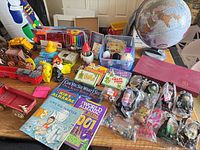 Overall view of mixed toys, books, games and marbles on tabletop