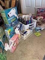 Group view with Conair dryer box, basket of hair products, soap packs, hair color kit