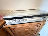 Front and side view of RCA VET250 VCR on wooden cabinet