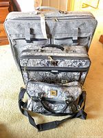 Front view of three travel bags showing sizes and patterns