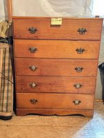 Front view of five-drawer solid wood dresser showing hardware and finish