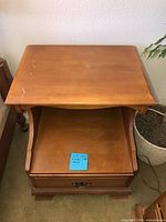 Top and front view of nightstand showing drawer, shelf and overall construction