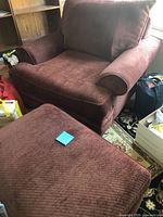 Full view of armchair and ottoman showing size and fabric