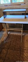 Full view of desk with riser shelf on top